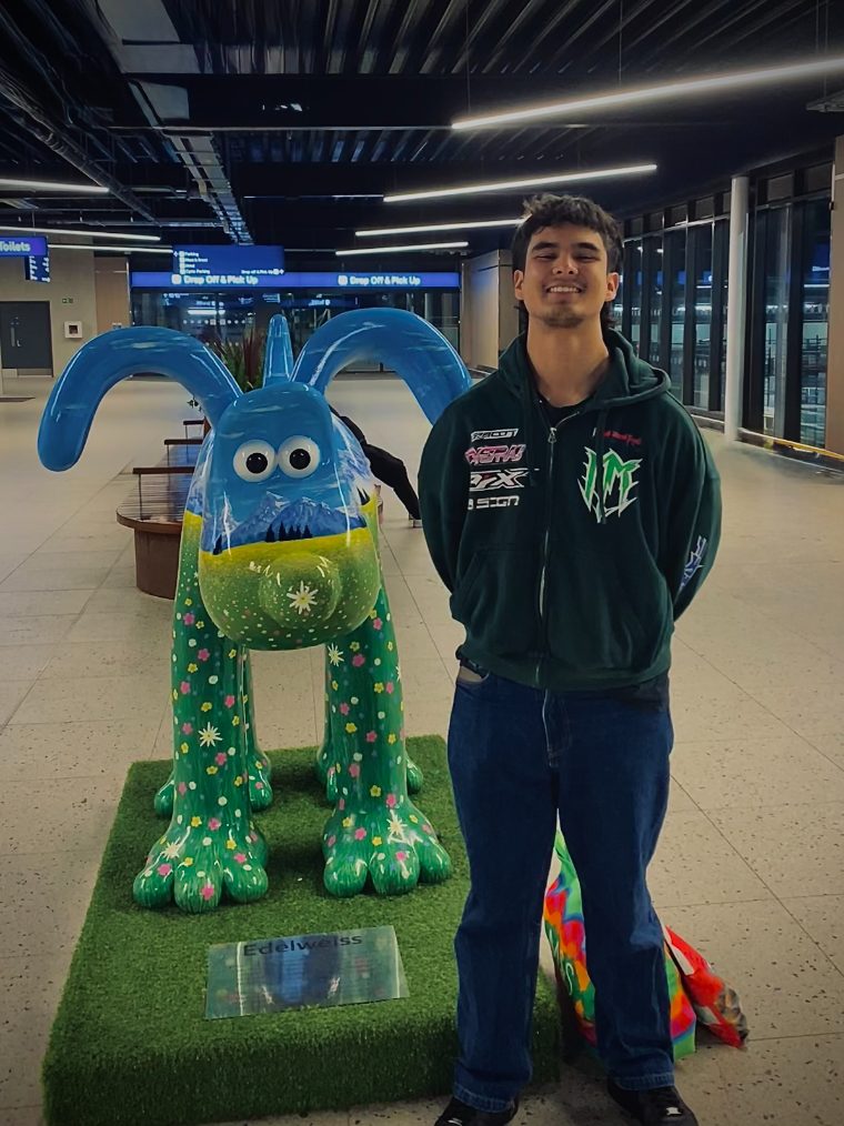 Michael Allen, founder of Micz Media, standing beside a painted Gromit sculpture